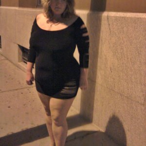 Married redhead walking downtown at night in minidress