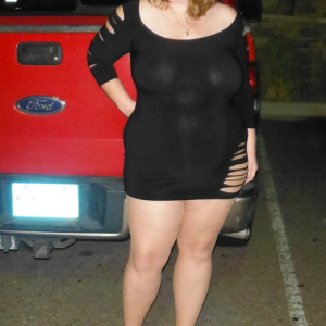 Married redhead in minidress pantyhose and heels waiting at night at a bar parking lot