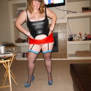 married redhead in black corset red miniskirt stockings and hooker heels waiting on my married bull for our date