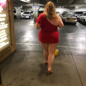 married redhead in a red minidress pantyhose and heels at a casino parking lot on a date with my bull